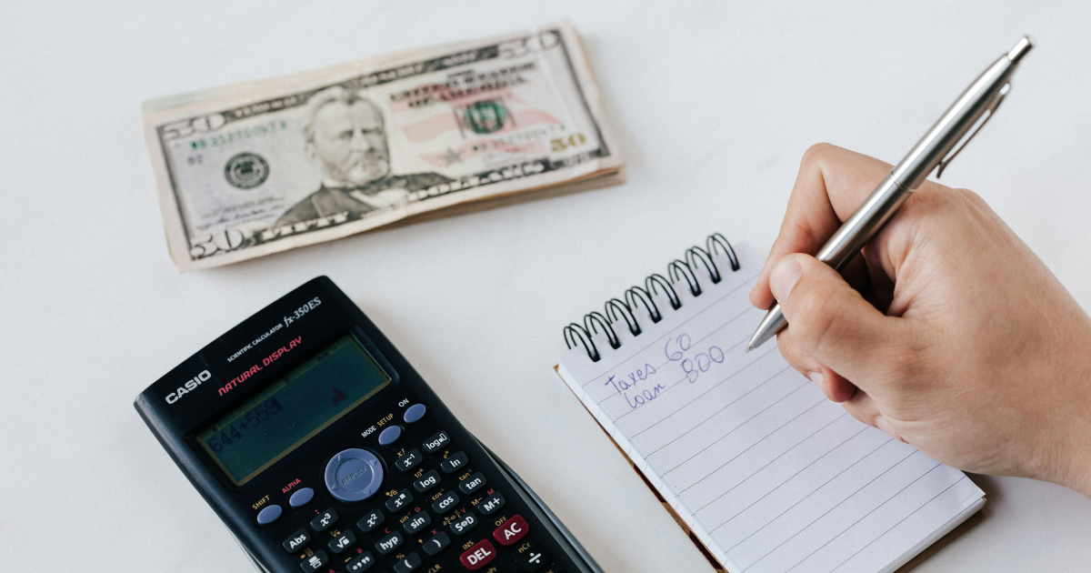  Calculator, currency notes, and written sum illustrating personal financial hacks as part of life hacks.