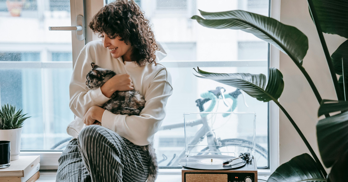 Image: Woman joyfully celebrating with her pet, illustrating the vibrant side of single life.