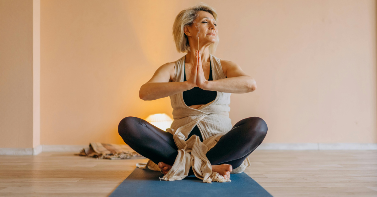 Image: Elderly woman confidently practicing yoga, showing happiness is achievable while single and alone