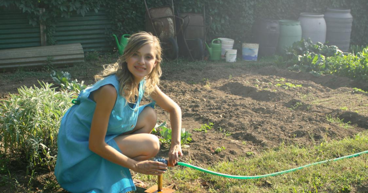 Young woman farming in off-grid living environment