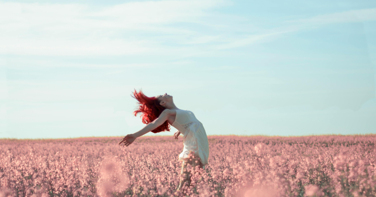 A woman embracing nature, finding liberation in letting go.