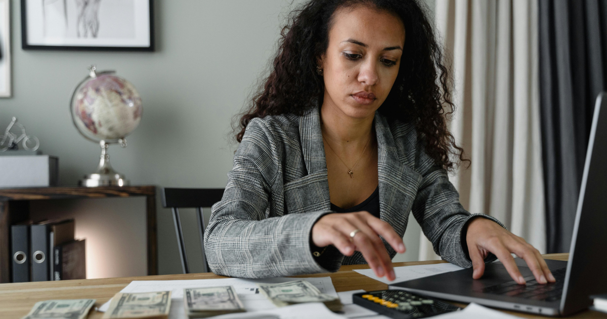 A woman carefully managing her budget, emphasizing the importance of financial planning after divorce.
