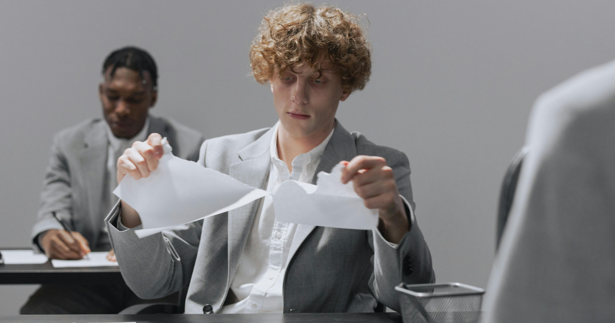 Image: Student tearing up exam paper in defiance.