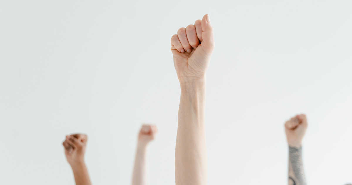 Image depicting raised hands, symbolizing rebellion or breaking rules.