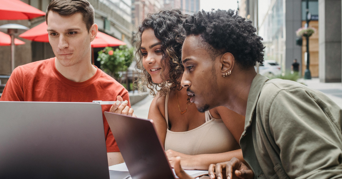 Image: Three friends browsing social media and discussing its positive aspects. 