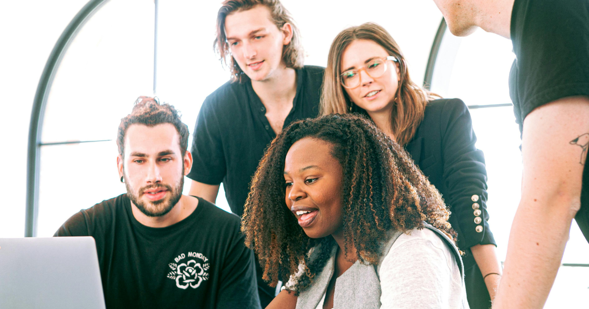 A group of youth working harmoniously in an office, showing the effects of Stoicism