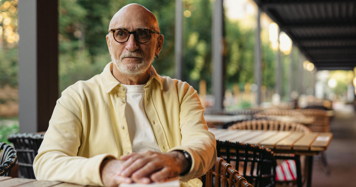 An elderly man sitting in a restaurant