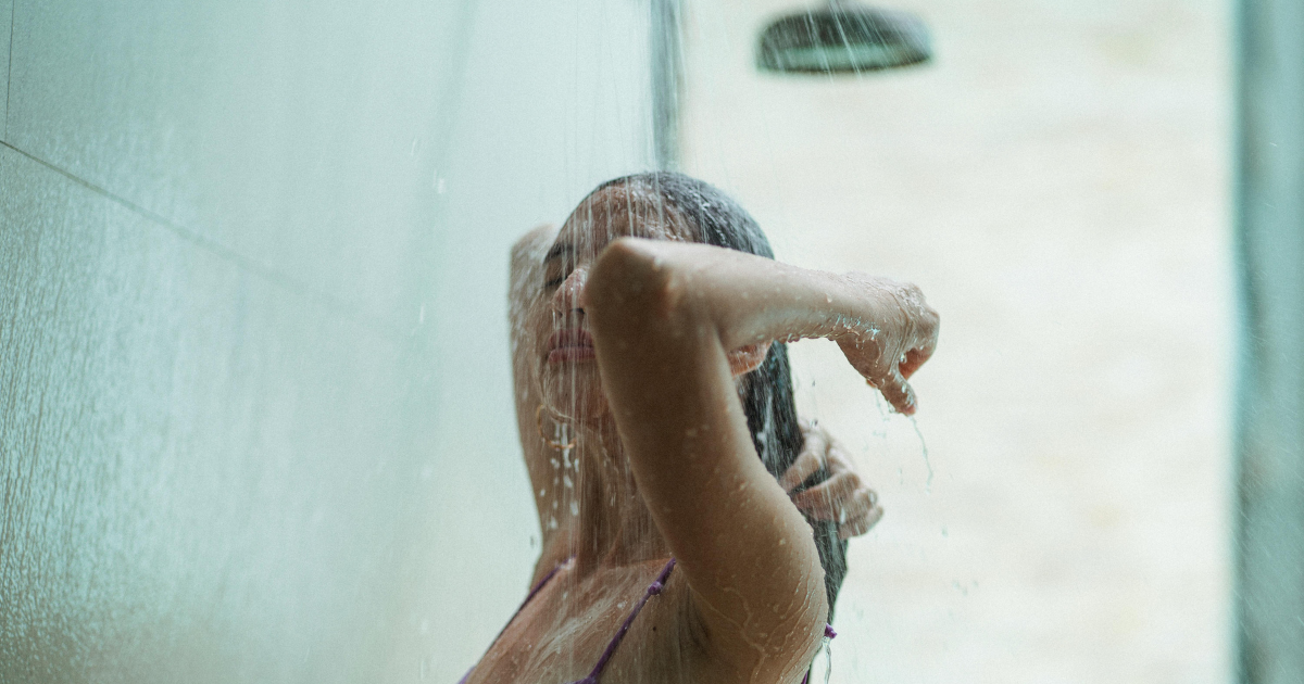 A woman taking a shower and refreshing herself as an important routine to remain fresh on summer days.