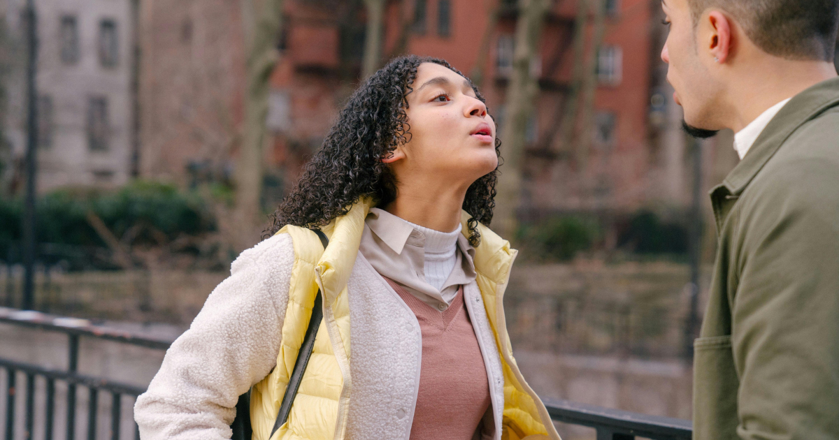 Woman with a determined expression on her face, engaged in a discussion with a man. Emphasizing the importance of saying no in personal life.