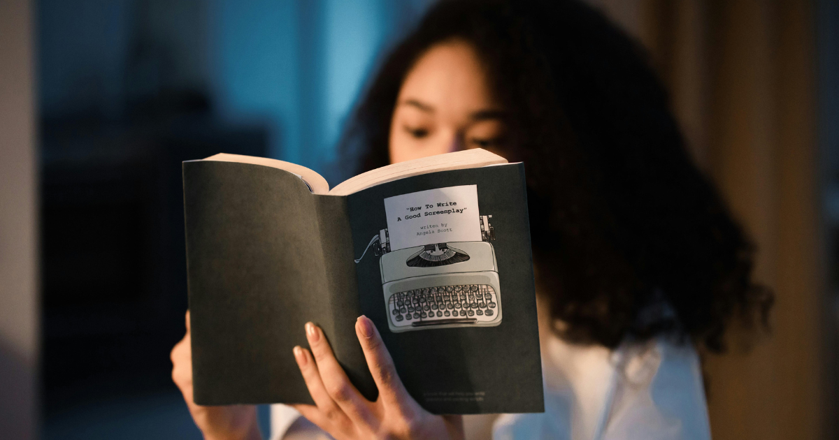  A woman reading books in the dark and silence, illustrating the need for quiet in learning.