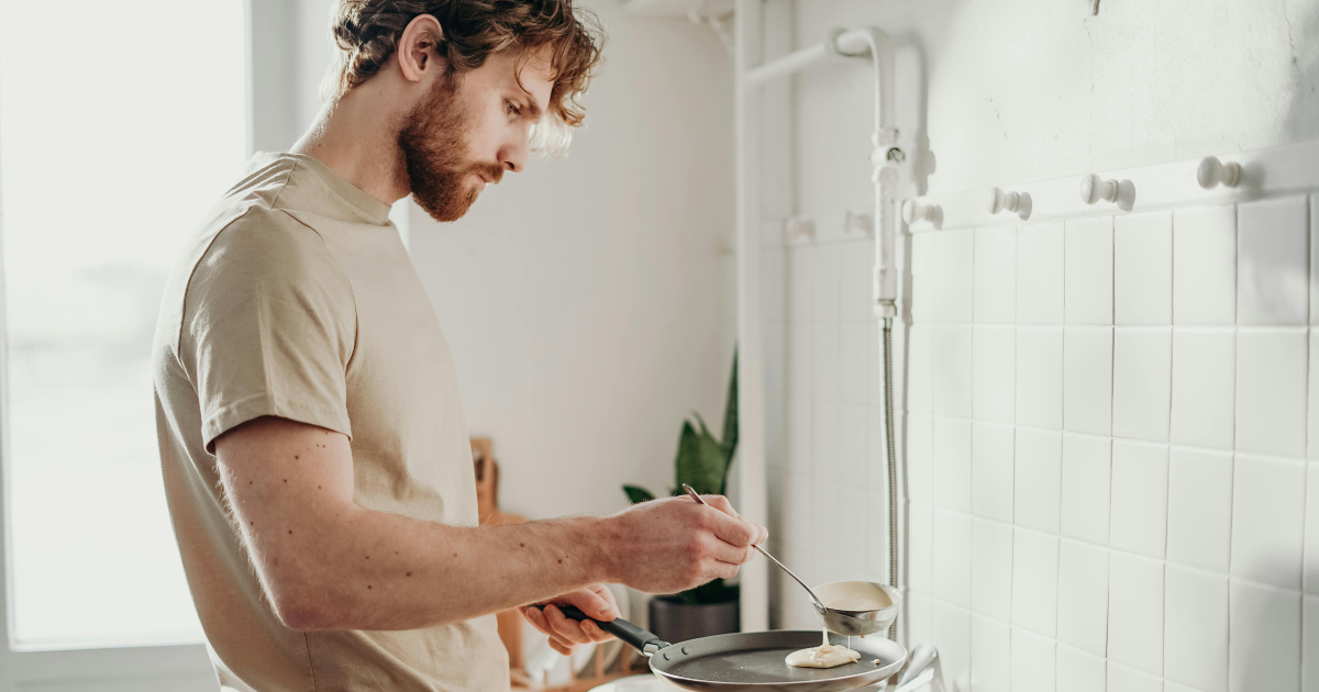 Man cooking alone in a kitchen, highlighting the significance of self-sufficiency and the experience of living alone.