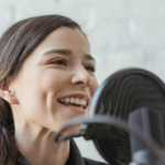 A joyful woman passionately tells a story using a stand microphone, illustrating the satisfaction and art of storytelling.