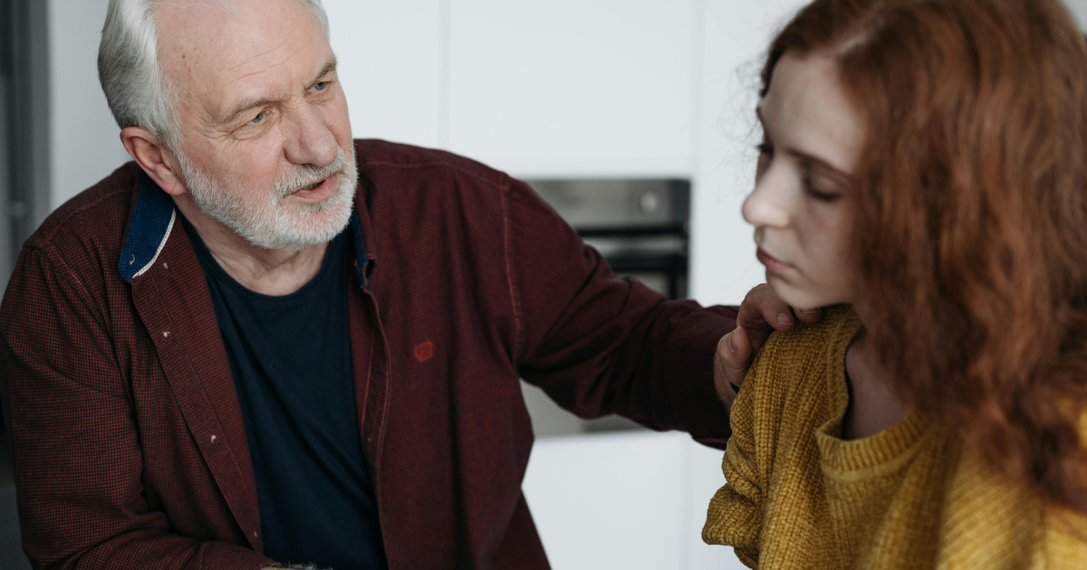 A father comforting his daughter who is feeling depressed, illustrating the importance of emotional intelligence in social and family life.